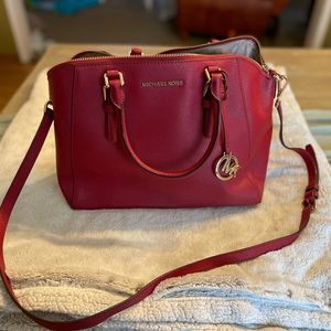 Red Michael Kors purse, can be worn as cross body